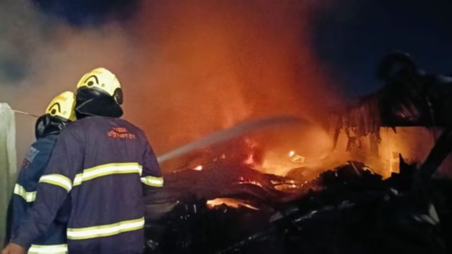 Damage at a Mantarwadi paint storage facility after a massive fire, with visible destruction to vehicles and equipment amidst the scorched remains.