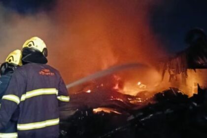 Damage at a Mantarwadi paint storage facility after a massive fire, with visible destruction to vehicles and equipment amidst the scorched remains.