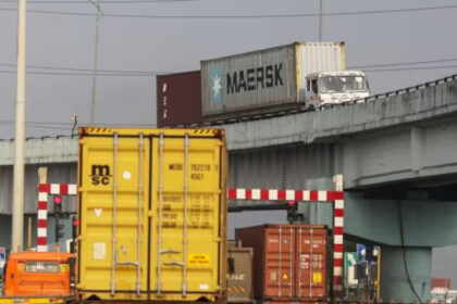 Urban freight trucks in a busy city street during peak hours.