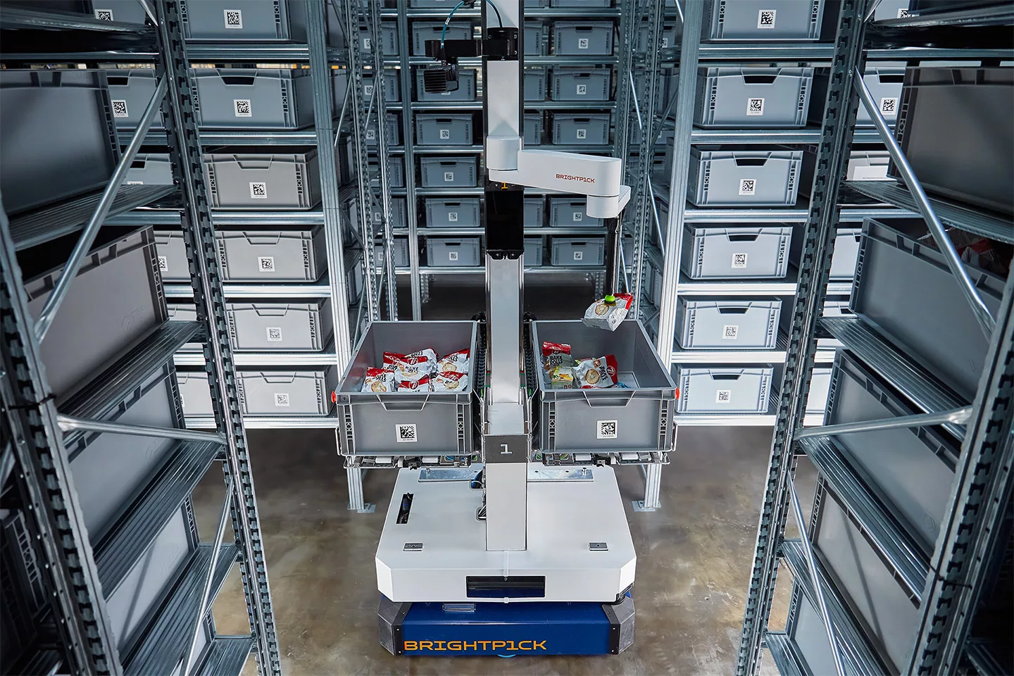 SCM Spectrum - Brightpick Autopicker robot picking items from high warehouse shelves using AI-powered machine vision and a robotic arm.