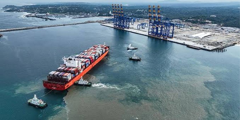 Aerial view of Vizhinjam International Seaport with large cargo ships docked and advanced port infrastructure in operation.