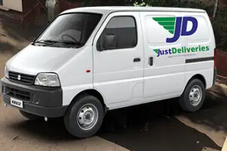 SCM SPECTRUM - JustDeliveries delivery van operating in an urban Indian city, representing mid-mile cold chain logistics