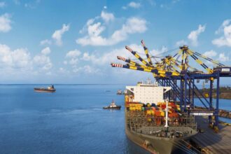 DP World container terminal with cargo ships and cranes at a busy Asian port