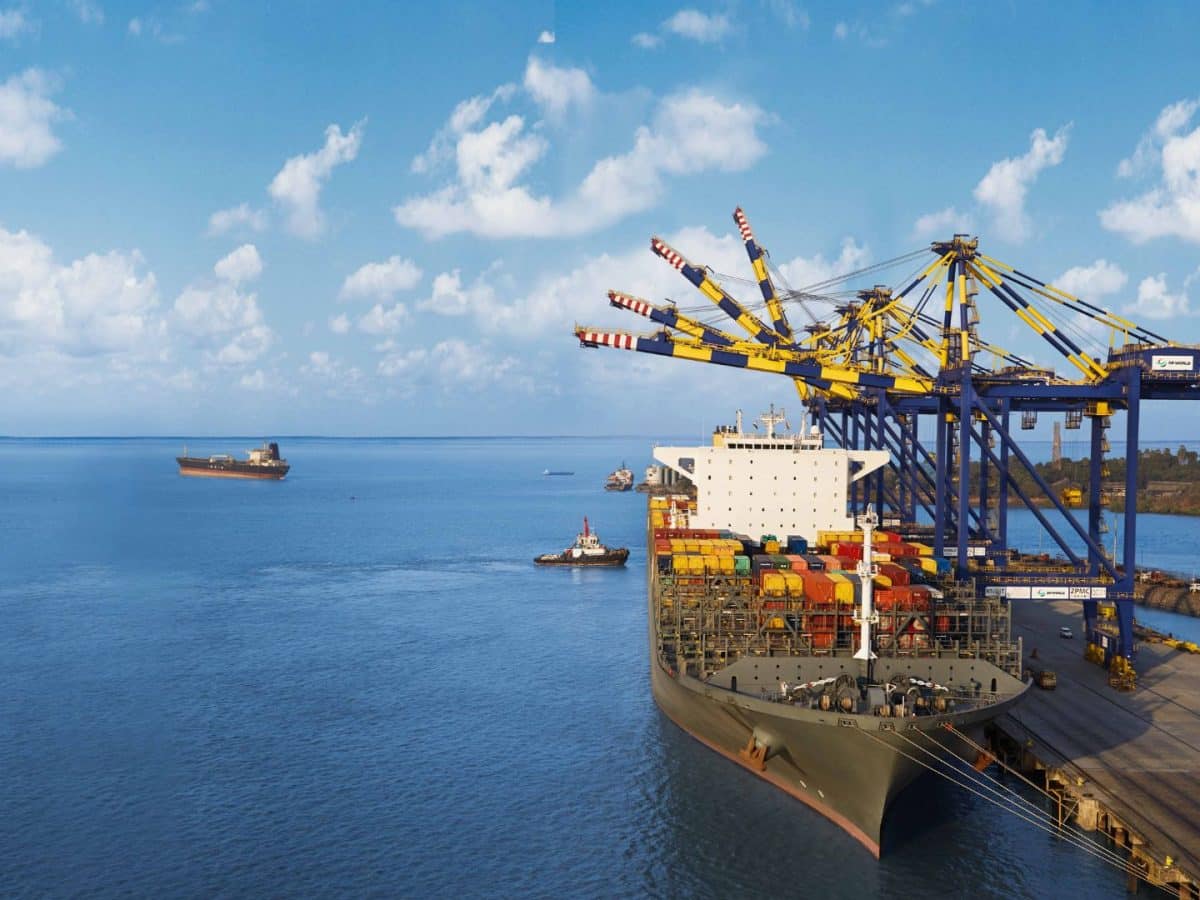 DP World container terminal with cargo ships and cranes at a busy Asian port