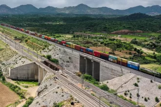 SCM SPECTRUM - Western Dedicated Freight Corridor freight train transporting double-stack containers across industrial hubs