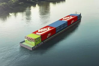CMA CGM electric river barge docked at Gemalink terminal in Vietnam with solar panels in background