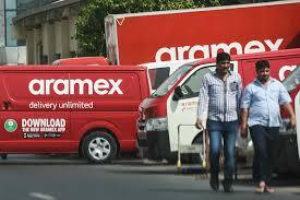 Emirates Post and Aramex executives announcing logistics partnership in Dubai branch.