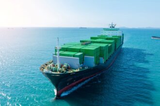 Green hybrid tugboat operating at an Indian port under the Sustainability Indexing initiative for greener shipping.